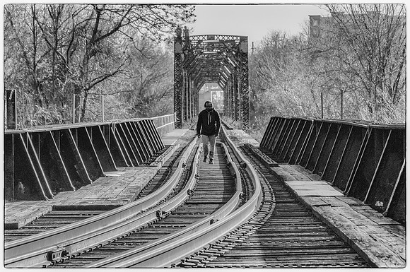 Man on Rail Bridge